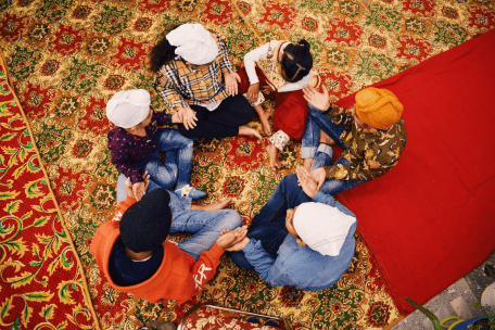 a group of people sitting on a rug